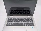 a laptop computer sitting on top of a white table