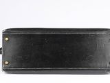 a black leather purse with gold studding on the front