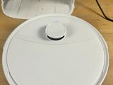 a white robot that is sitting on a wooden table