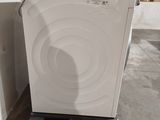 a washing machine sitting on a pallet in a warehouse