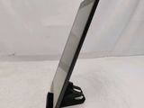 a close up of a tablet computer on a stand on a white surface
