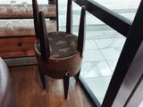 a small table with two chairs in front of a window