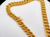 yellow gold plated chain necklace on a mannequin base