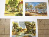 three paintings of different landscapes on the floor