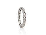 a close up of a diamond ring on a white surface