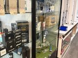 a glass display case filled with various items in a store