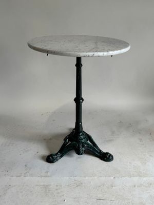 an image of a marble top table with a black metal base
