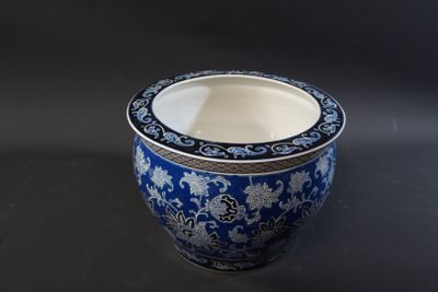 a blue and white vase sitting on a black table