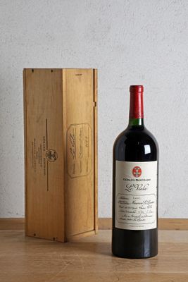 a bottle of wine next to a wooden box on a table