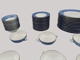 many plates and bowls arranged in a circle on the table