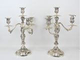 pair of silver plated candelabs with flowers and leaves