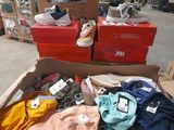 a cardboard box filled with clothes and shoes in a warehouse