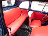 two red seats in the back of a blue car