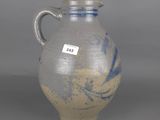 a blue and white vase with a tag on it