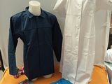 two shirts on a table next to a mannequin
