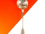 une cuillère posée sur une table orange et blanche