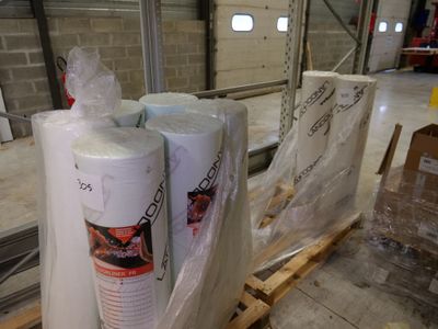 several rolls of toilet paper sitting on top of a pallet in a warehouse
