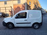 a white van that is parked on the side of the street