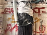 a mannequin in a room with graffiti on the wall