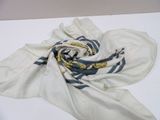 a white scarf with a blue and yellow design on it