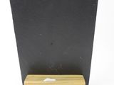 a close up of a black board on a wooden stand