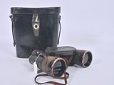 two binoculars sitting next to each other on a white surface