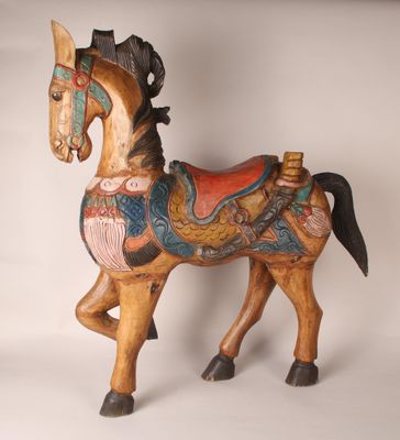 a wooden horse that is standing on a white surface