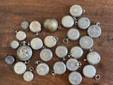 a close up of a wooden table with a bunch of silver coins