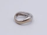 a close up of a silver ring on a white surface