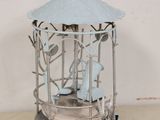 a bird cage with a bird inside of it on a table