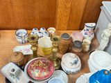 a wooden table with a lot of dishes and cups on it
