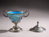 pair of silver and blue glass vases with lids on a table