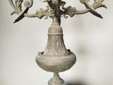 a candelier that has a bird on top of it