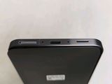 the back of a black cell phone sitting on top of a table