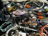 many different types of jewelry on a table together