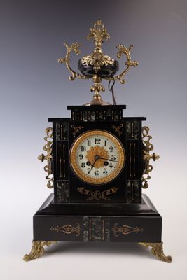 a black and gold clock with a crown on top of it