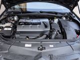 the engine of a car with its hood open on the street