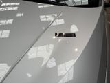 a close up of the hood of a white sports car