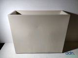 a white planter sitting on a table with a white background