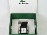 a box with a watch inside of it on a white surface