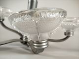 a glass chandelier with three lights attached to it