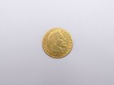 a close up of a gold coin on a white surface