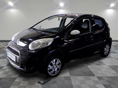 a picture of a small black car parked in a garage