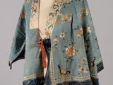 an image of a woman ' s jacket on a mannequin stand