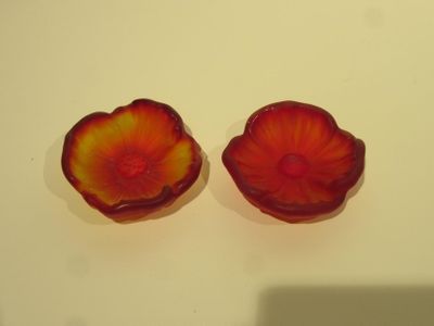 pair of red and yellow flower shaped glass bowls on a white surface