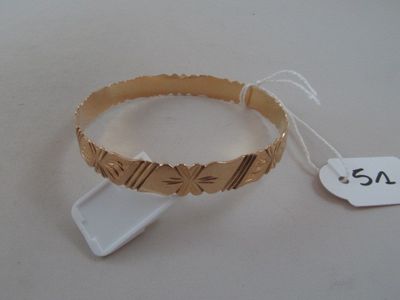 a bracelet that has a tag on it on a table