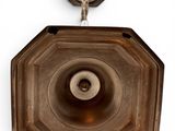 a metal object hanging on the wall with a hook