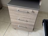 a desk with a computer on it in the corner of a room