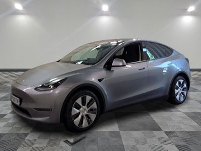 une photo d'une Tesla Model Y argentée posée sur un sol à damier