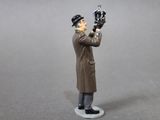a figurine of a man in a trench coat holding a baseball glove